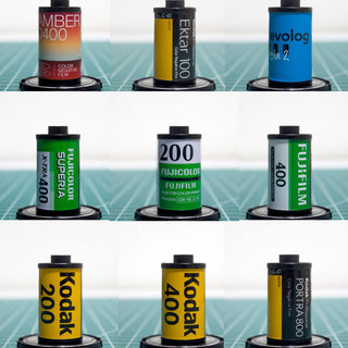 Close-up 35mm film canisters, 3 rows of 3 each depicting Kodak, Fuji and other manufacturers