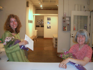 Andrea and a photographer share a moment before a gallery show at Photolab Berkeley
