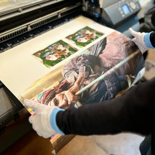 A technician works with several oversize fine art prints from an imagePROGRAF iPF8400 printer at Photolab Berkeley
