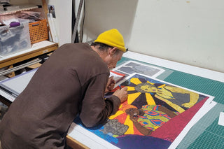 A technician works on large art prints at Photolab of Berkeley