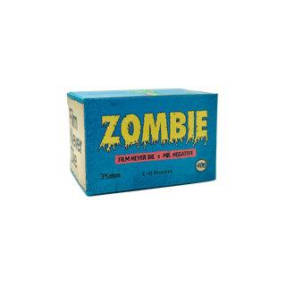 A box of 35mm C-41 process film labeled 'ZOMBIE' in dripping yellow letters, with a blue front panel and cream side panel, photographed on a plain white background.
