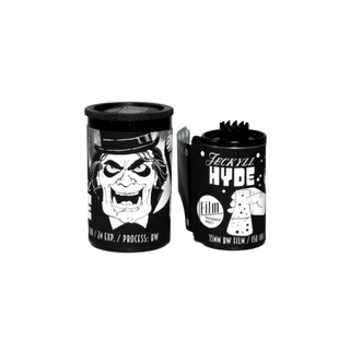 Two black film canisters for a projector, featuring a stylized white and black illustration of a man's face on one canister and the text 'Jackyl HYDE' on the other, shown against a plain white background.