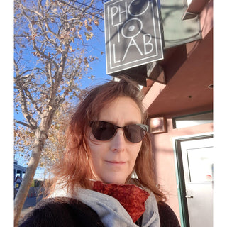 Lab manager Melissa Smith poses under the sign at Photolab of Berkeley.